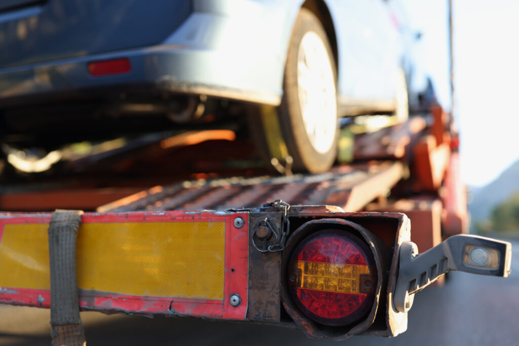 Broken Car Is Being Loaded By Tow Truck
