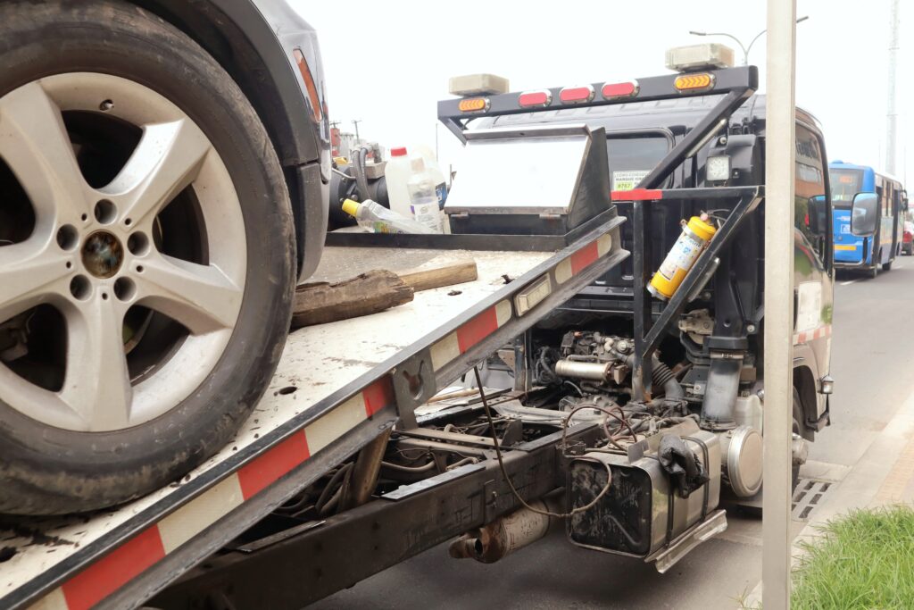 Black Crane Loading Damaged Vehicle With Hook