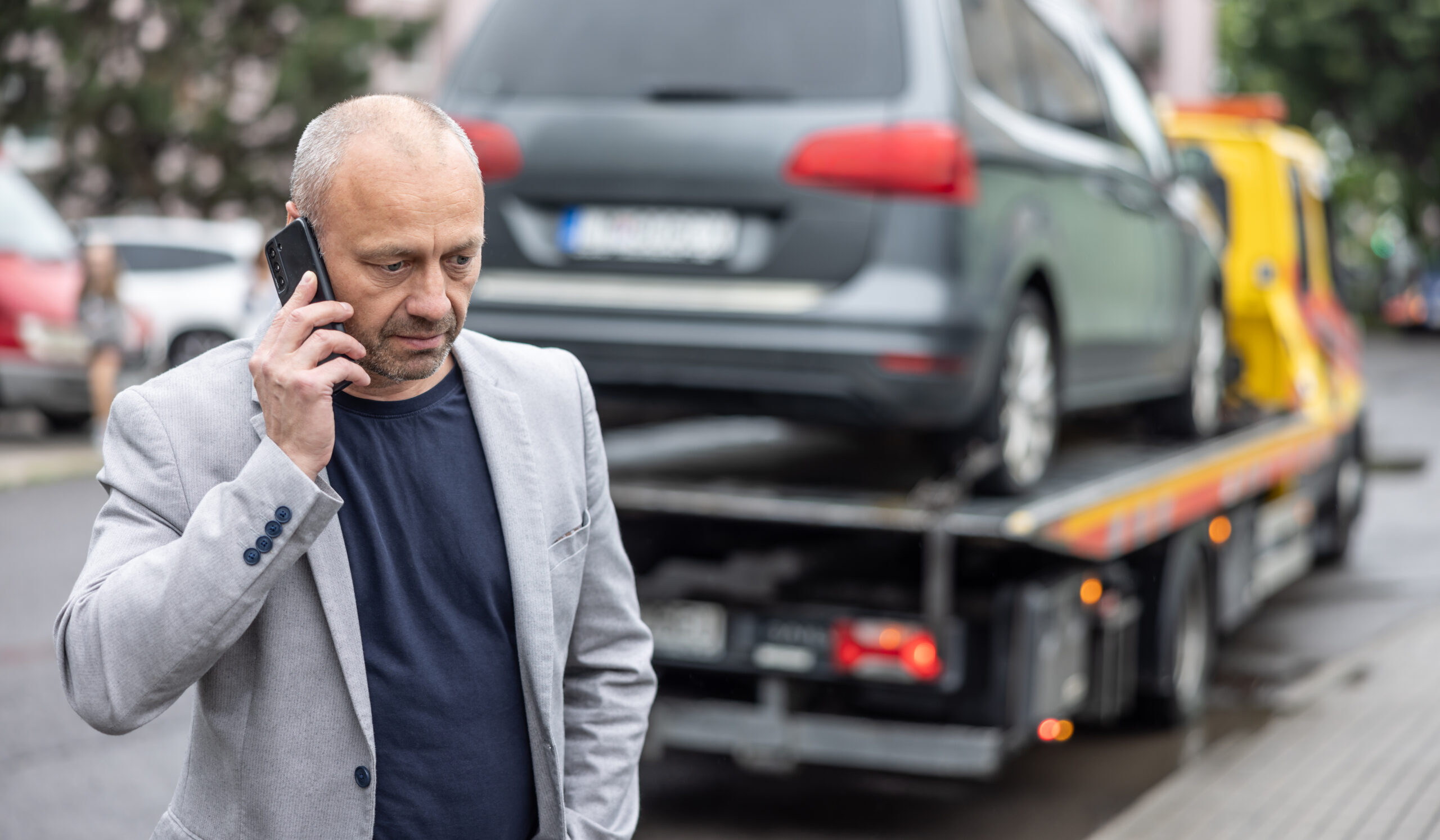 Elegant Middle Age Business Man Calling Insurance While Towing Service Helping His On The Road. Roadside Assistance Concept